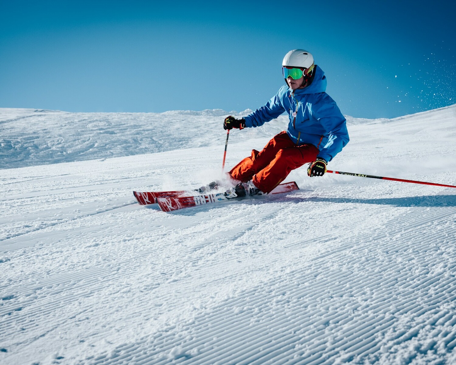 man ice skiing on hill